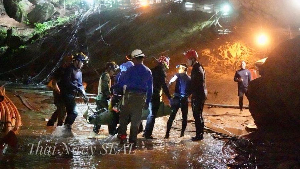 A picture released by the Seal team shows a person being stretchered out of the cave