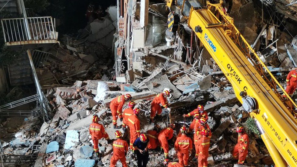 This photo taken on July 12, 2021 shows rescuers searching at the site of a hotel
