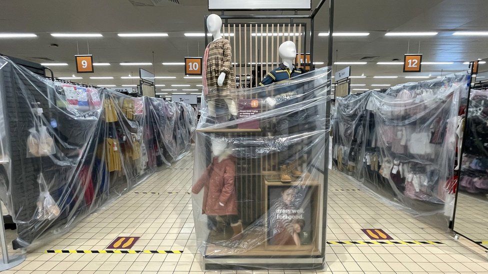 Clothes rails covered in cellophane in Sainsburys in Cardiff