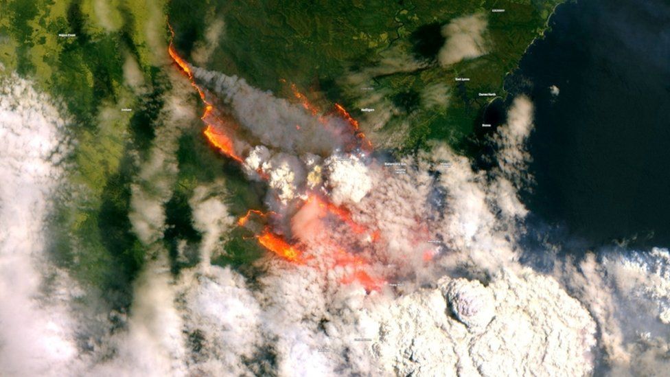 A satellite image of Batemans Bay, NSW, shows smoke and fire from wild bushfires