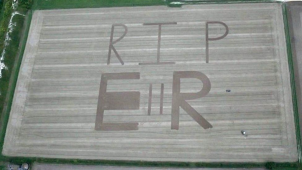 Aerial photo of the Queen's Cypher in a field