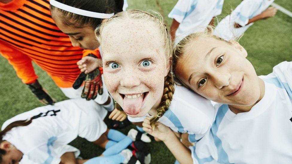 Girls playing football