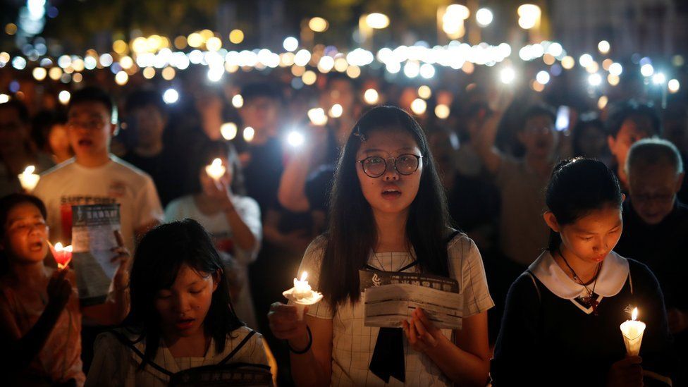 Thousands of people take part in a candlelight vigil to mark the 30th anniversary