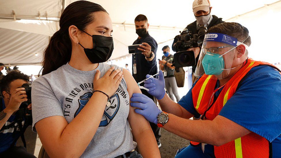 A woman receives a coronavirus vaccine in Los Angeles
