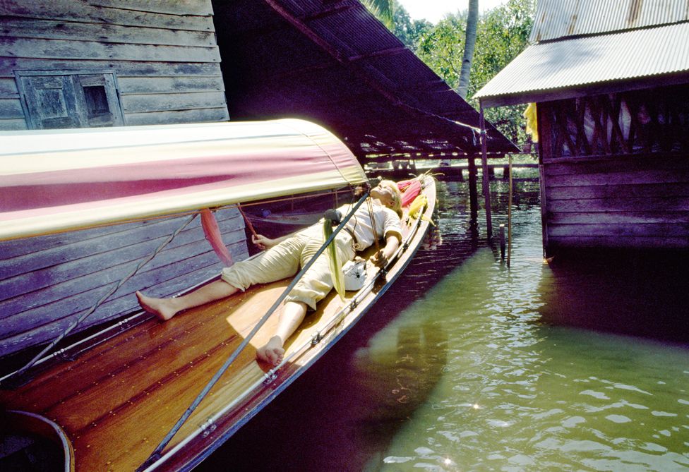 David Bowie relaxing on the river in Bangkok at the end of the tour.