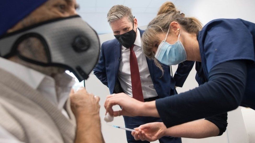 Sir Keir Starmer watches covid vaccination