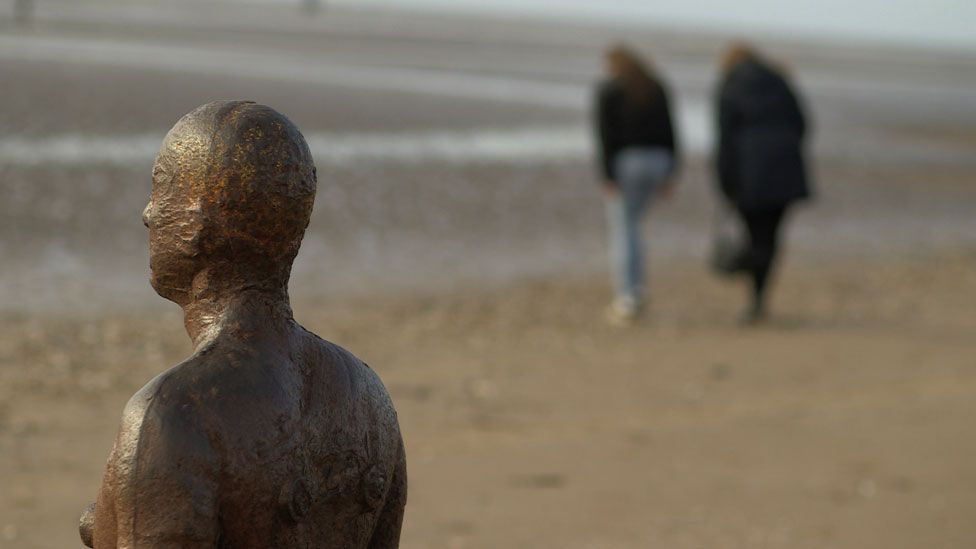 Iron statue on beach