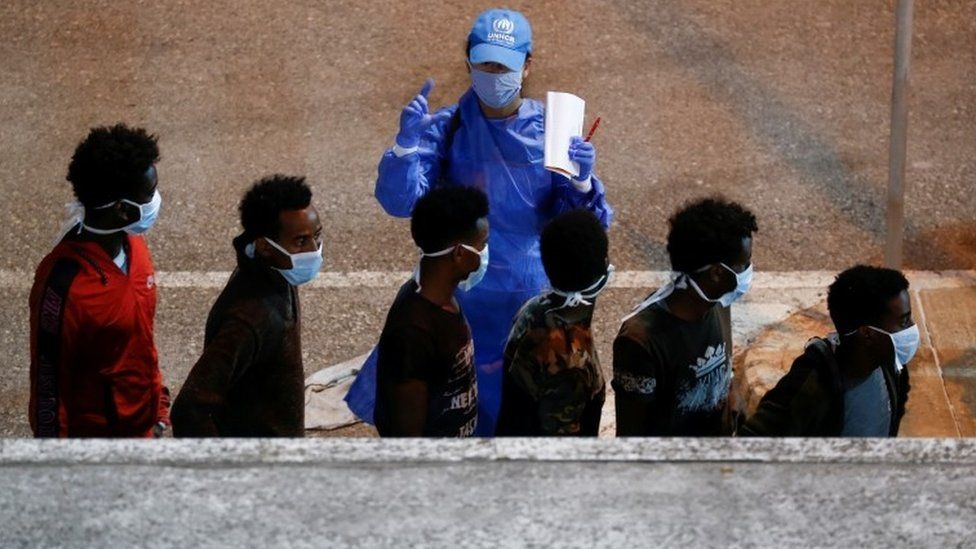 Rescued migrants are being checked by a United Nations High Commissioner for Refugees (UNHCR) worker