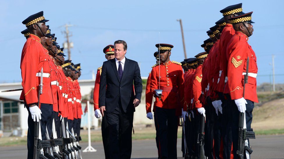 David Cameron greeted by guard of honour at the airport in Kingston