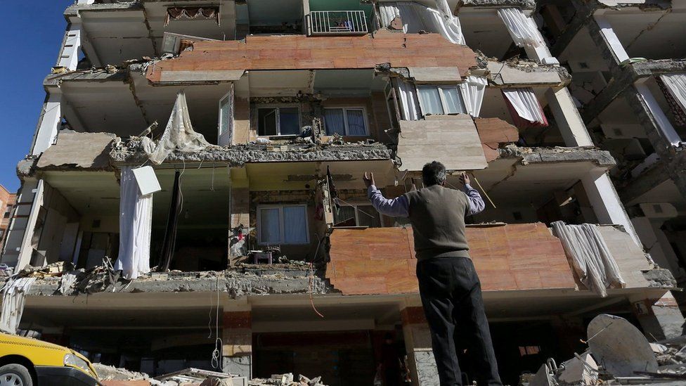 A man reacts as he looks at a damaged building in Sarpol-e Zahab county in Kermanshah, Iran November 13, 2017.