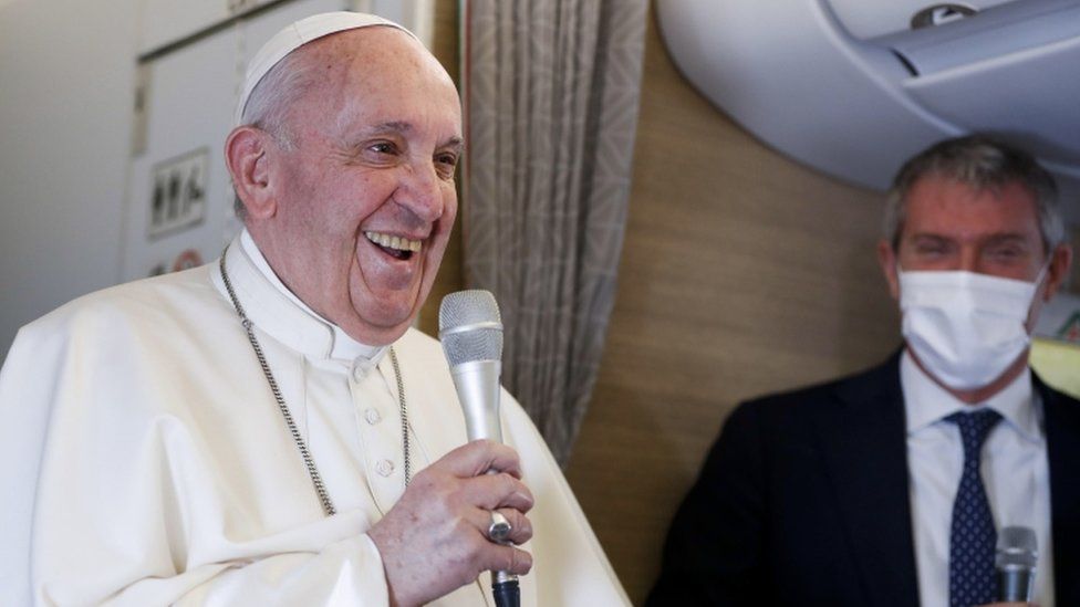 Pope Francis gives a news conference aboard the papal plane on his flight back after visiting Iraq