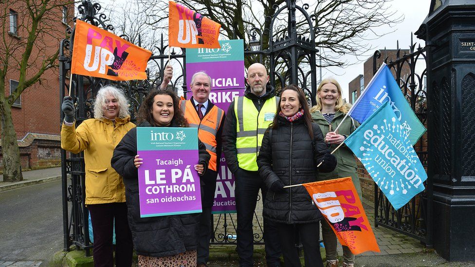 Teachers and staff pictured on strike outside St Malachy