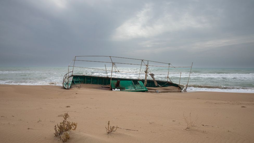 A migrant boat, likely to have originated from North Africa, on a beach near Agrigento, Sicily