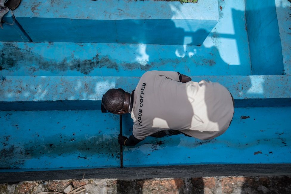 Koko Bikuba, 37-year-old former combatant, checking the coffee-washing area. 14 April 2022.