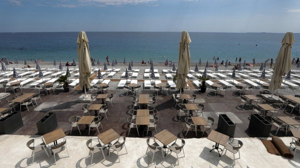 Tables and deckchairs are set out to respect social distancing on the Promenade des Anglais beach in Nice