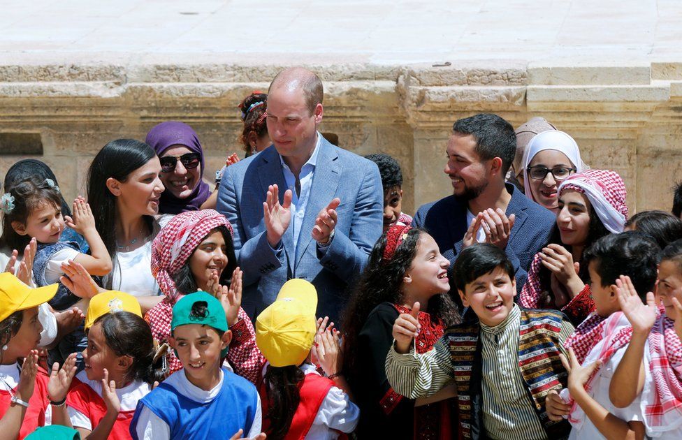 Prince William and Jordan's Crown Prince Hussein interact with children at the ancient city of Jerash