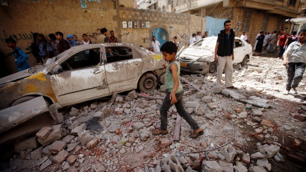 People at the site of an air strike launched by the Saudi-led coalition in Sanaa, Yemen May 16, 2019.