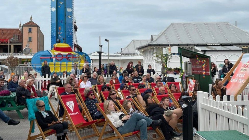 People watching a screening on Brighton Palace Pier