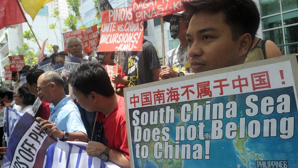 Protesters with placards at a rally in front of the Chinese Consulate in Manila's financial district, denouncing China's claim to most of the South China Sea