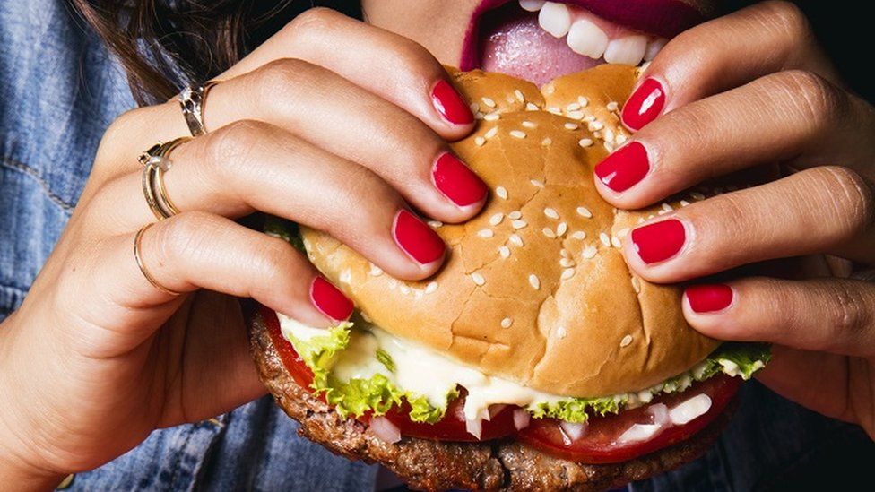 Woman eating a vegan burger