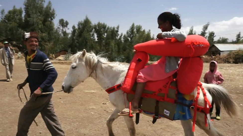 A woman using a specially developed horse saddle