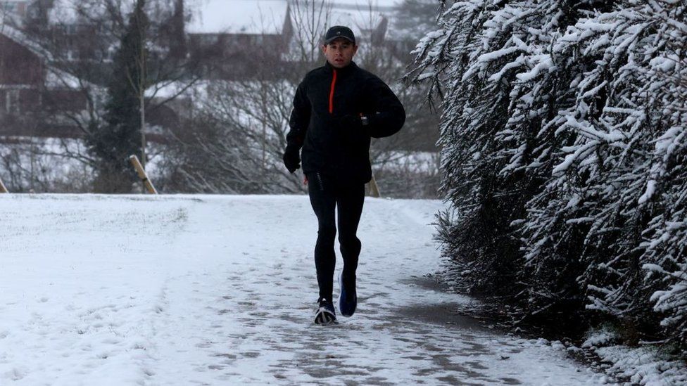 A runner braves freezing conditions in a park in Blackwood, Wales