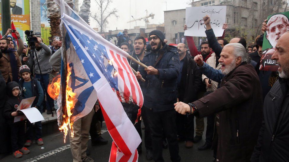 Iranians burn US and Israeli flags during anti-US protests over killing of Qasem Soleimani in Tehran, 4 January 2020