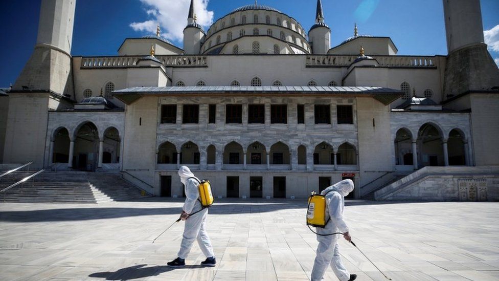 Municipality workers in protective suits disinfect courtyard of the Kocatepe Mosque