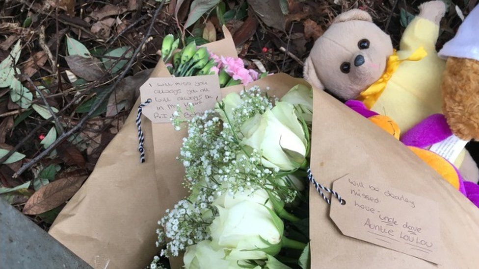 Floral and toy tributes at the scene