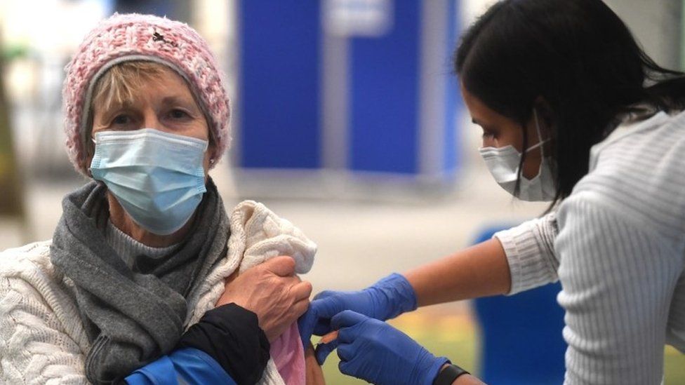 Woman receiving Covid vaccine in London