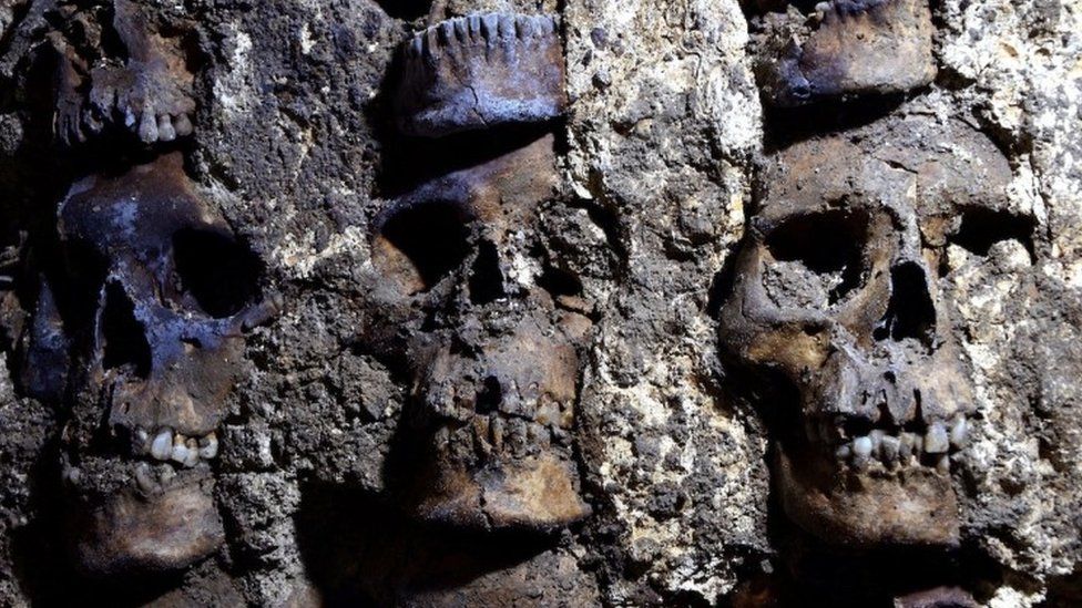 A photo shows parts of an Aztec tower of human skulls, believed to form part of the Huey Tzompantli