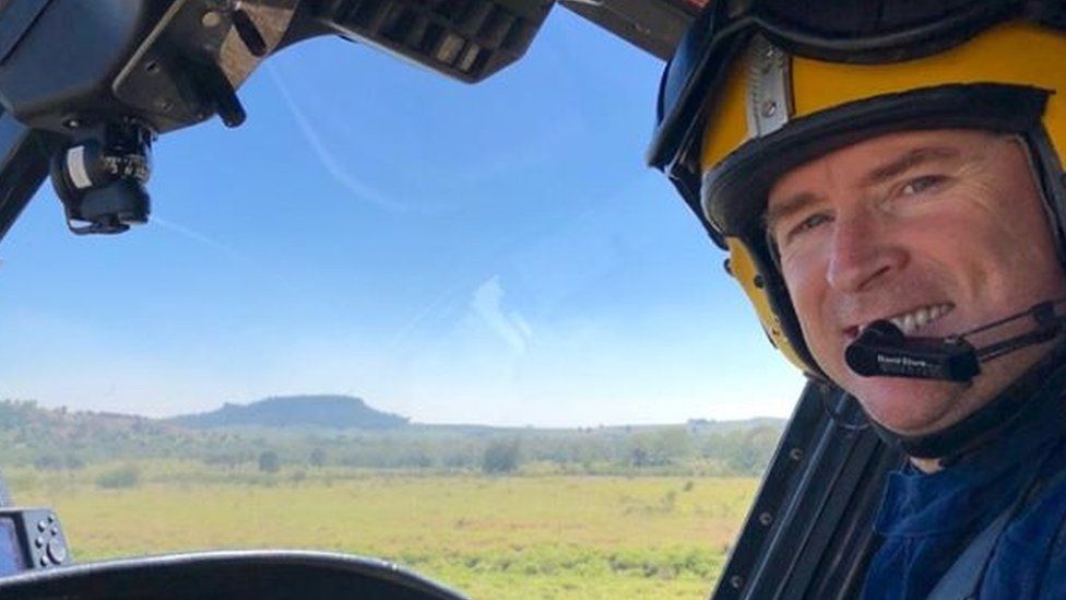 Dan O'Dwyer flying a helicopter over the Australian outback