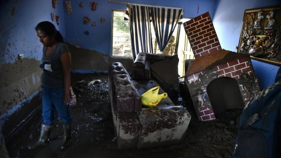 A woman observes her house after a flooding of La Paila river in the municipality of Corinto, Department of Cauca, Colombia, 08 November 2017.