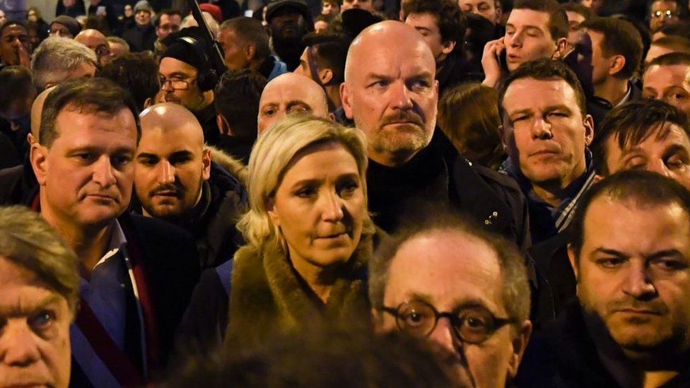 Marine Le Pen stands in the middle of a group of demonstrators at a silent march in Paris on 28 March 2018 for an 85-year-old Jewish woman killed in an antisemitic attack