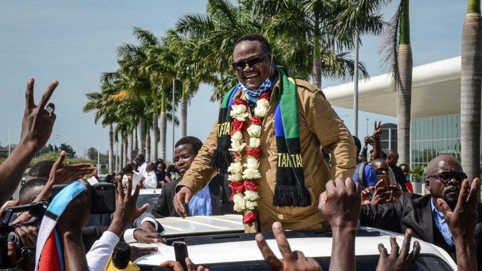 Tundu Lissu (C), Tanzania's former MP with the Chadema main opposition party, who was shot 16 times in a 2017 attack, reacts to supporters as he returns after three years in exile to challenge President John Magufuli in elections later this year, at Julius Nyerere International Airport in Dar es Salaam, Tanzania, on July 27, 2020. - Tanzania will hold a general election on October 28, 2020