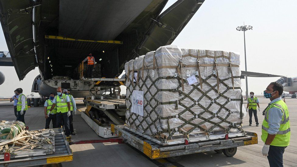 US aid is unpacked from an aircraft in Delhi