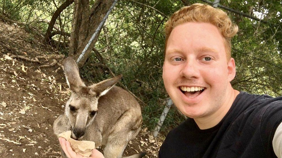 Luke Shortland with a kangaroo on his year abroad in Australia