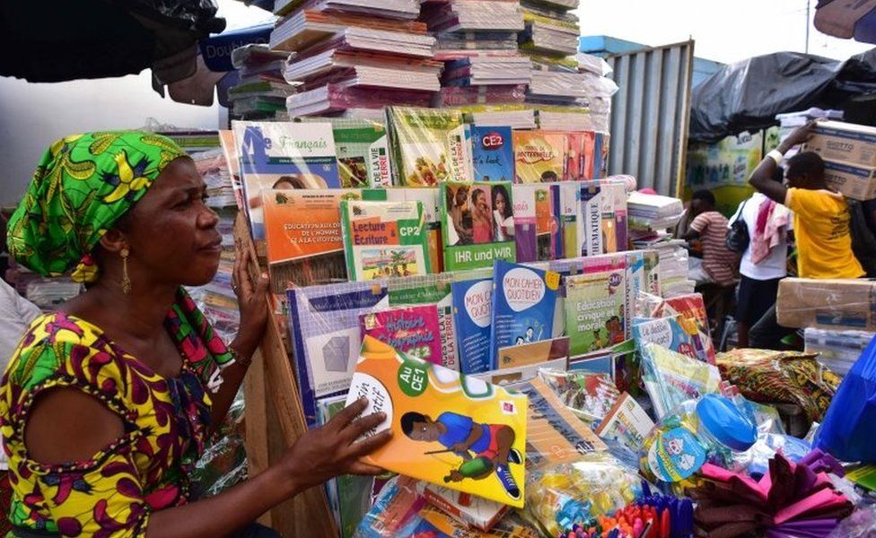 A woman sells second-hand books and magazines at a roadside bookshop in Ivory Coast"s largest city Abidjan on September 19, 2018.