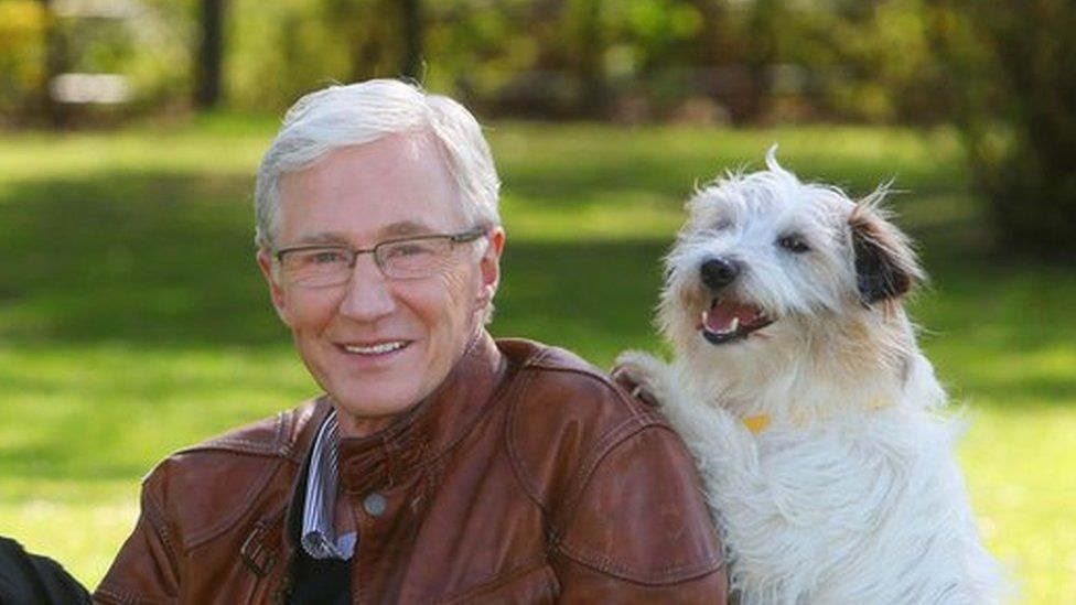 Paul O'Grady with rescue dogs Razor a German Shepherd, Moose a Rottweiler and Dodger a Terrier at London's Battersea Park