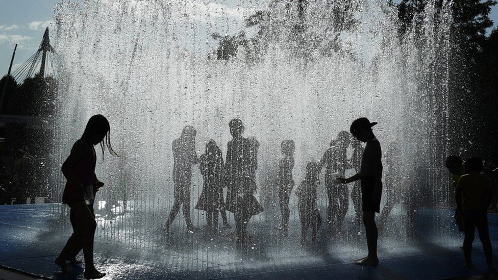 Children play in the fountains by the River Thames in London on 6 August 2018