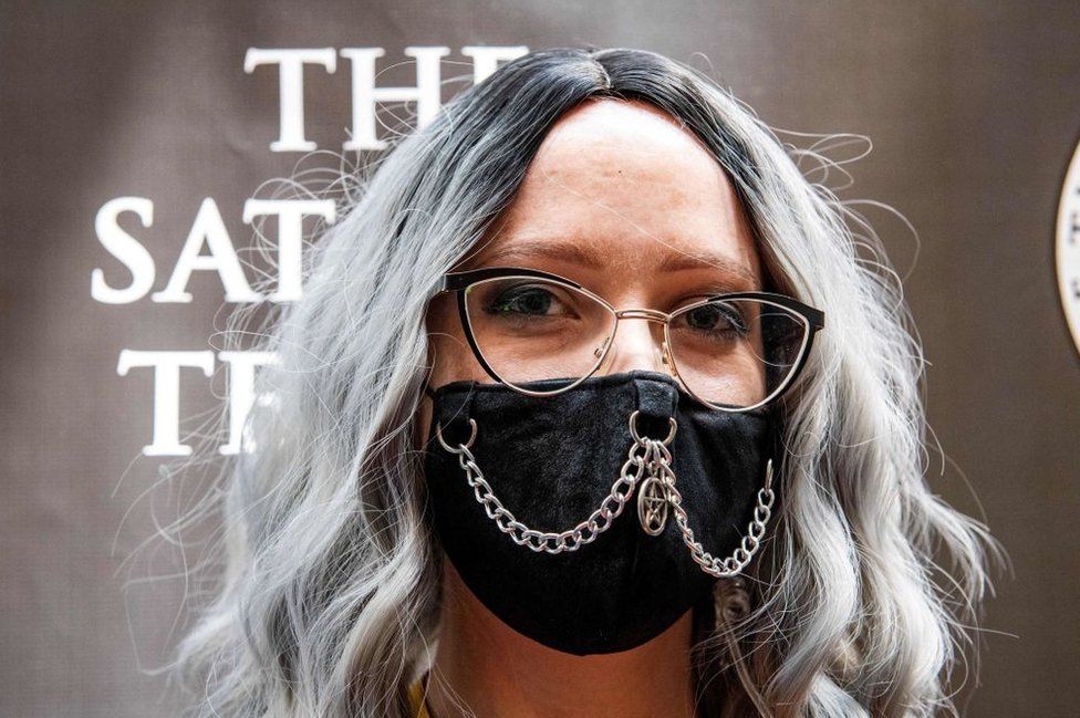 Chalice Blythe, a programming director for SatanCon, pictured wearing a silver chain and a pentagram charm on her Covid-19 mask