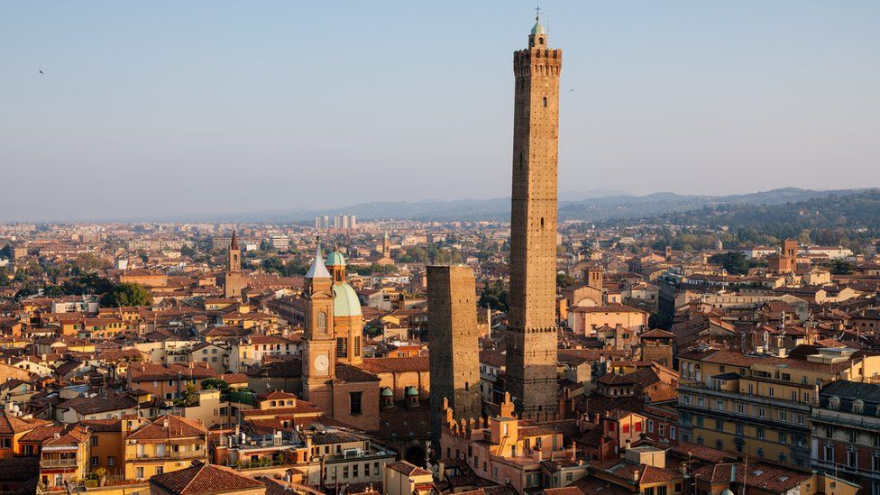 The skyline of Bologna is seen dominated by the Garisenda and Asinelli towers