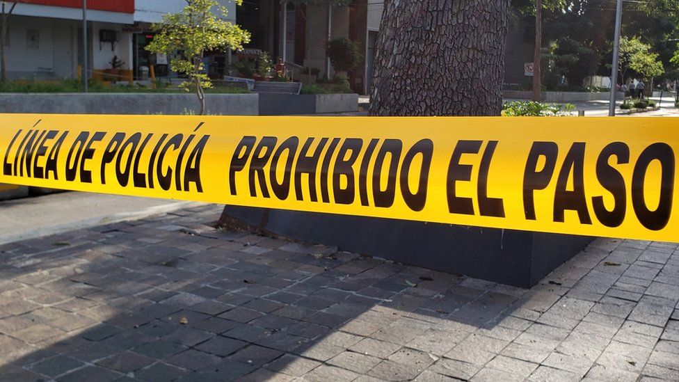 Police tape can be seen in strung across a street in central Guadalajara