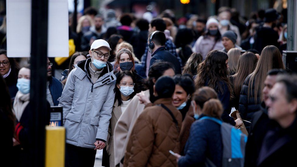 People wear masks on a busy Oxford Street in London
