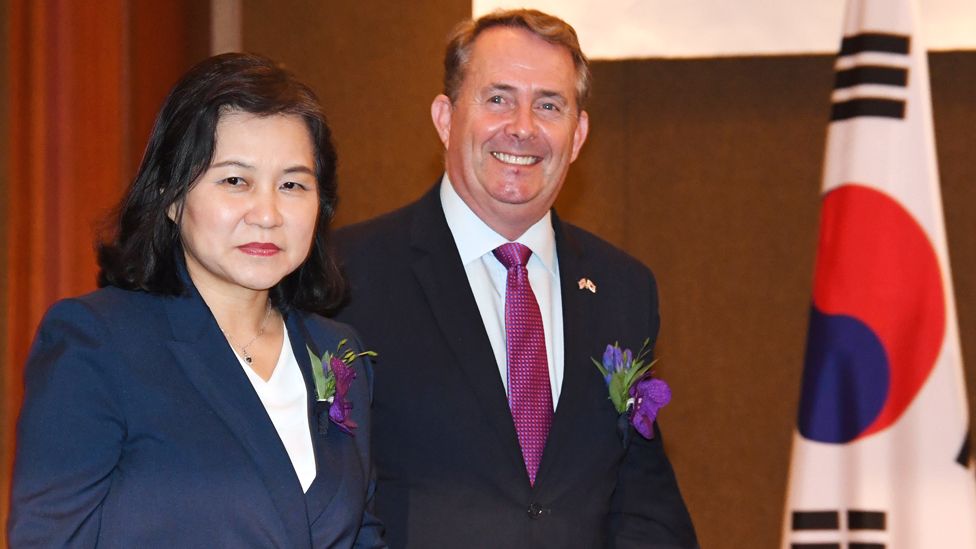 South Korean Trade Minister Yoo Myung-hee (L) and British counterpart Liam Fox (R) arrive for signing of a document of the Free Trade Agreement (FTA) between South Korea and UK