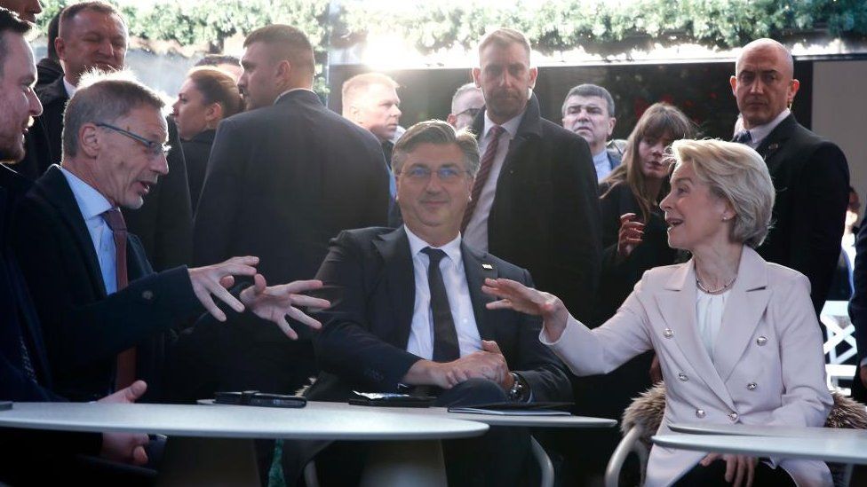 Croatian Prime Minister Andrej Plenkovic (C) talks with President of the European Commission Ursula von der Leyen (R) and Croatian National Bank Governor Boris Vujcic (L) at a cafe bar in Zagre