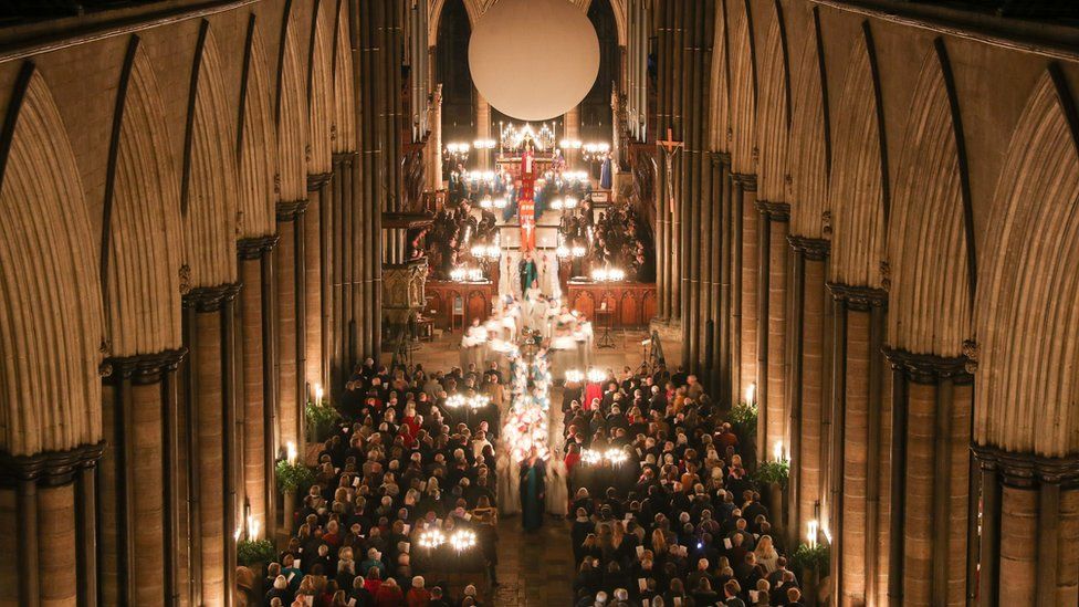 Candles are carried through Salisbury Cathedral during the advent procession