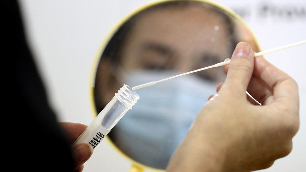 A woman using a coronavirus test