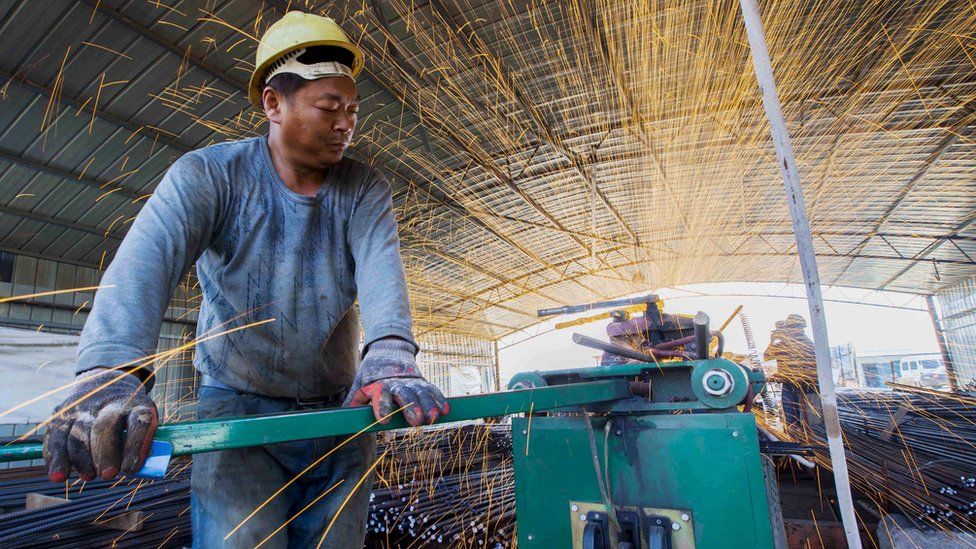 A labourer cuts steel bars at a railway bridge construction site in Lianyungang, Jiangsu province, China