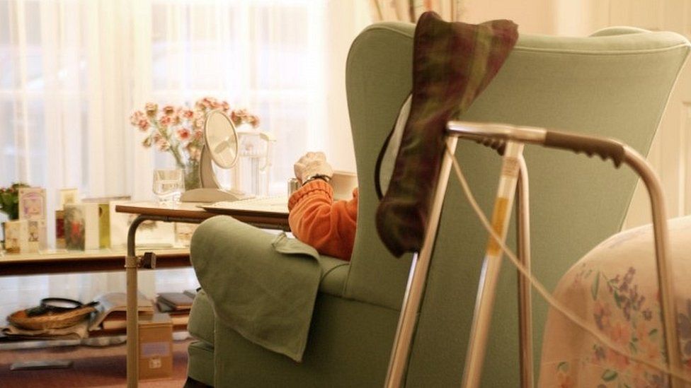 Elderly man sitting in a chair